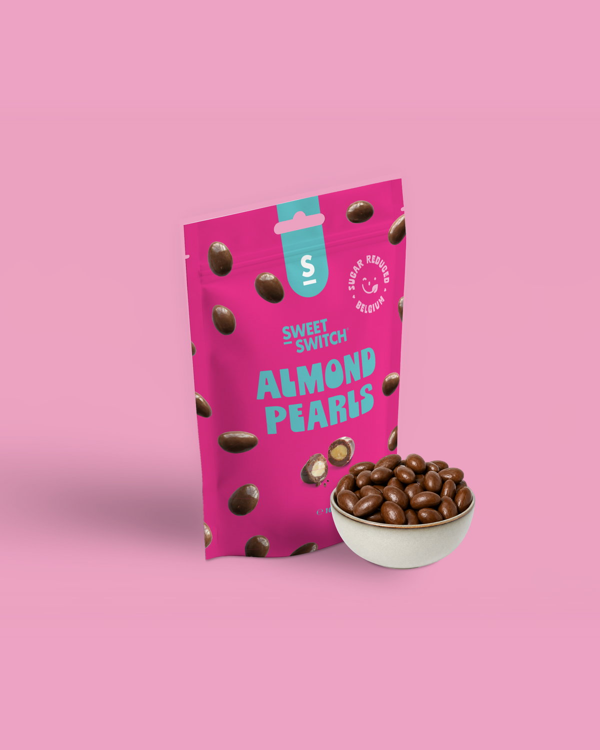 Pink package of Sweet Switch Almond Pearls with a bowl of almonds on a pink background sugar free